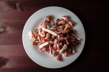 seafood salad on a plate on a wooden table
