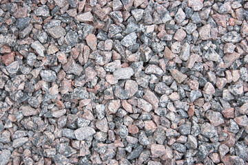 Background of red granite rubble of various sizes