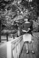 Fototapeta premium black and white portrait of a woman, in a business style, with documents and a calculator