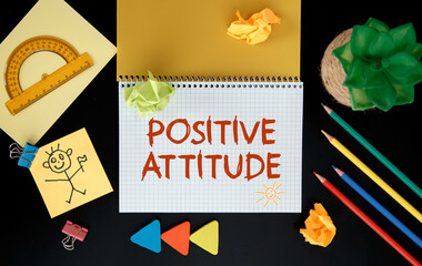 Positive Attitude. Inspirational motivating quote on notebook