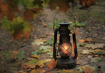An old kerosene lamp in the autumn forest.
