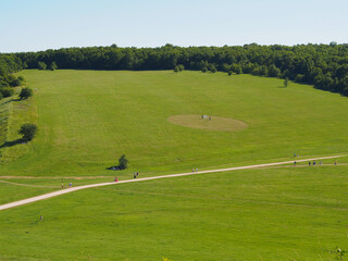 Green grass, river, field and blue sky. Copy space for text.