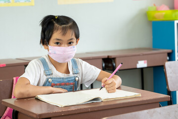 Kids wearing mask protect and safety from corona virus in classroom,Back to school after covid-19 quarantine and lockdown.