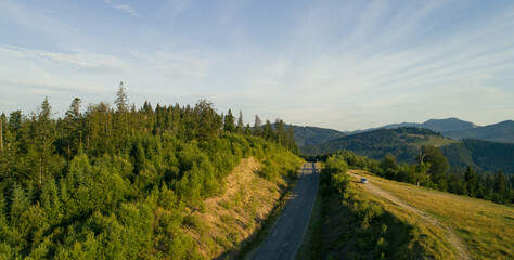 Mountain road. Landscape with rocks, sunny sky with clouds and beautiful asphalt road. Travel background. Highway in mountains. Sunrise mountain beautiful view. fog in the mountains. Aerial view.