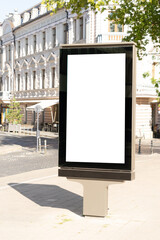 Mockup of blank white city outdoor advertising vertical billboard stand in old town street