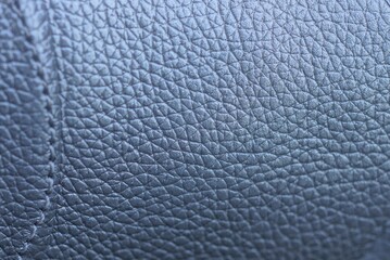gray background from a piece of leather with a seam