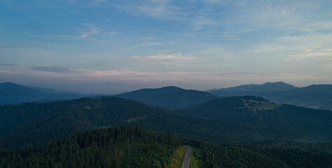 Mountain road. Landscape with rocks, sunny sky with clouds and beautiful asphalt road. Travel background. Highway in mountains. Sunrise mountain beautiful view. fog in the mountains. Aerial view.