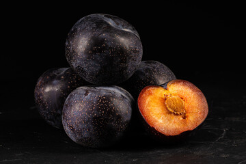 Purple plum on black background