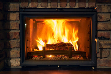 fireplace and fire close view as object or background, brick wall