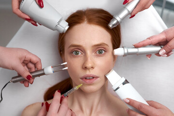 several beauticians holding their equipment near female face, beauty and cosmetology concept....