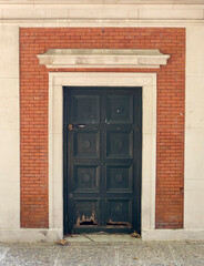 Old nineteenth century wooden carved door with metal ornaments.