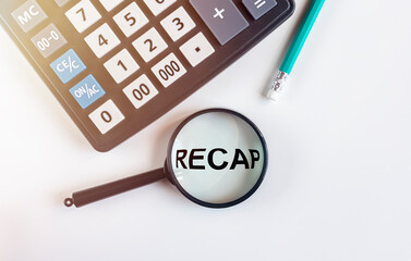 Recap word inscription through magnifying glass on white table with calculator, recap in finance