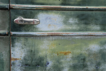 Abstract of 1928 Chevrolet green door with handle