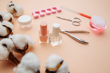 Beauty care. Tools for creating and for the treatment of nails on pink table.
