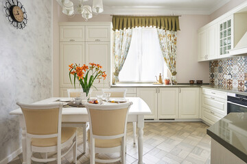 Classic white kitchen with served dining area