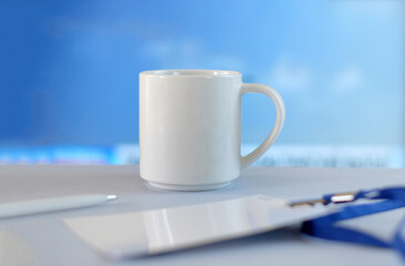 White cup, badge and pen on white table soft blue background, business style