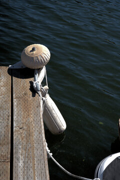 Buoy and float on the dock near a boat.