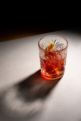 alcoholic cocktail with lemon in a glass crystal glass shadow