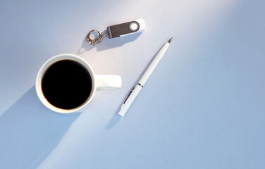 Memory card, pen, cup of coffee on grey background with copy space, minimalism business style