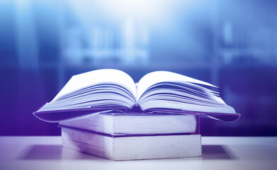 Book stack in the library and blurred bookshelf background for education. education background. back to school concept.