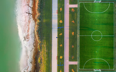 Soccer field in the park by the river, top view