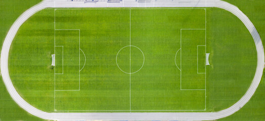 Fototapeta premium Soccer field with white markings. Top view.