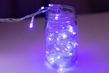 Lights inside the glass jar, colorful light glowing in the dark inside the jar. selective focus