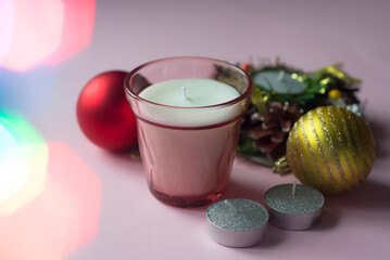 Christmas holiday composition. Xmas decorations, candles, on pink background.