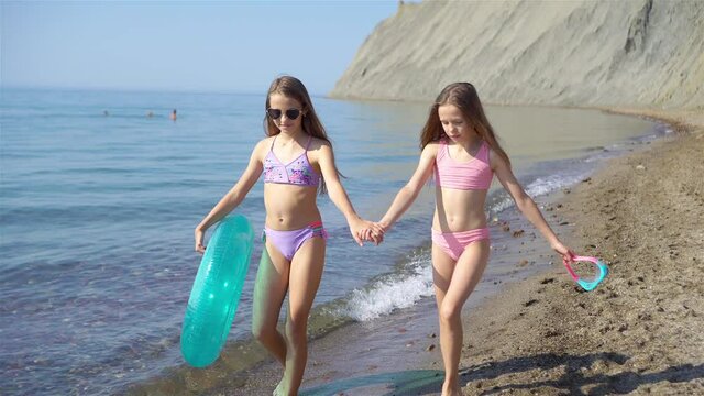 Adorable little girls having fun on the beach