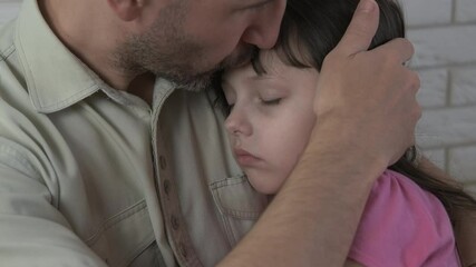 Father with a sleeping child. Portrait of a little sleeping girl on her dad's shoulder.