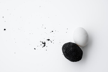 An old duck egg recipe in ash. Salty pickled duck egg in ash on a white background