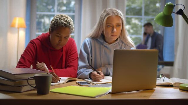 college students studying together at dorm and working on project