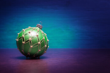 Christmas bauble against blue background with copy space