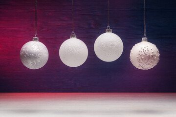 Four Christmas balls over pink-blue wooden background. Xmas and New Year concept