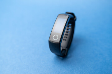 fitness bracelet on blue background