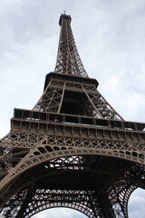 A bottom perspective view of the steel structure of the Eiffel Tower in Paris
