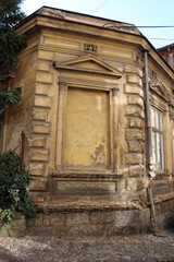 An old, dilapidated townhouse with a fake window opening