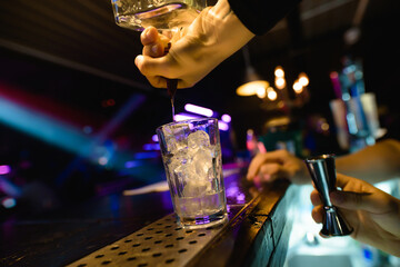 Bright cocktails - shots at the bar. Colorful footage in a nightclub. Alcoholic drink of different colors. Nightlife scene. Shots at the bar table. Several glasses of alcohol 