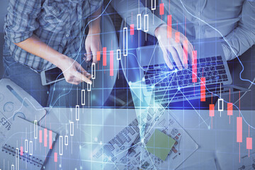 Multi exposure of man and woman working together and forex graph hologram drawing. Financial analysis concept. Computer background. Top View.