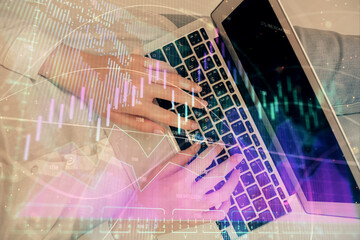 Double exposure of woman hands working on computer and forex graph hologram drawing. Top View. Financial analysis concept.