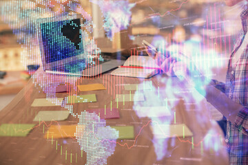 Double exposure of woman hands working on computer and forex graph hologram drawing. Financial analysis concept.