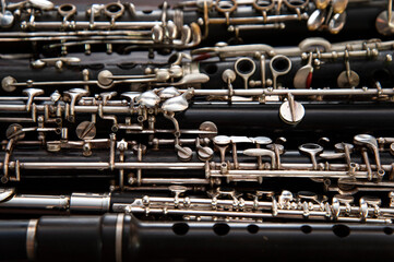 Many woodwind instruments lie on a wooden surface. View from above.