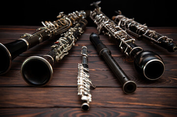 Woodwind instruments lie on a wooden surface. Side view - obrazy, fototapety, plakaty