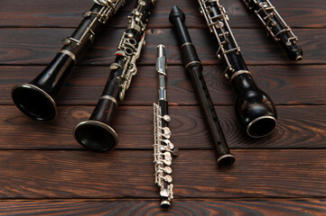 Woodwind instruments lie on a wooden surface. View from above © viktor