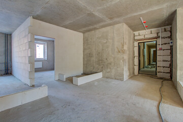 Unfinished construction empty room. Walls from lightweight aggregate concrete blocks with empty...