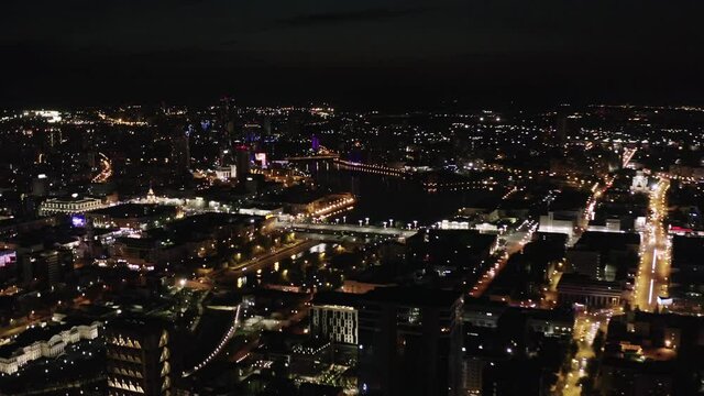 Stunning aerial view of Ekaterinburg illuminated at night. Stock footage. View from plane above the modern city, contrast of shining lights and black sky.