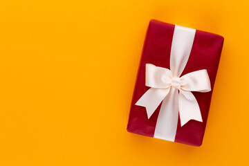 Christmas gift boxes with ribbons on color tabletop.