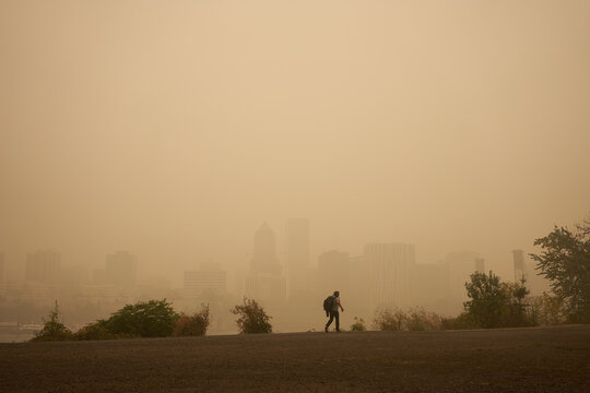 An orange smoke-filled sky is seen above Portland's downtown skyline during the Oregon wildfires.