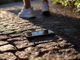 A man walking away after losing his phone on the sidewalk