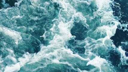 Beautiful turquoise sea waves lapping below with a lot of foam and splashes in slow motion, seamlessly looped. - Powered by Adobe